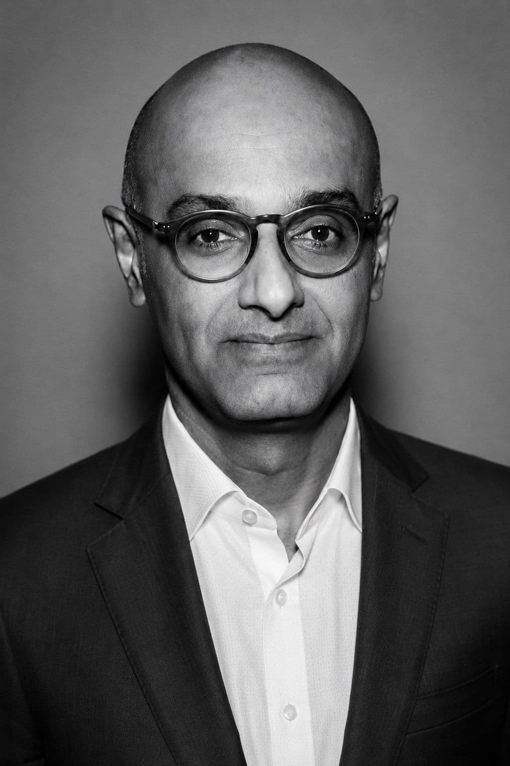 Himal Mathew, head and shoulders, looking directly at the camera, against a plain wall.